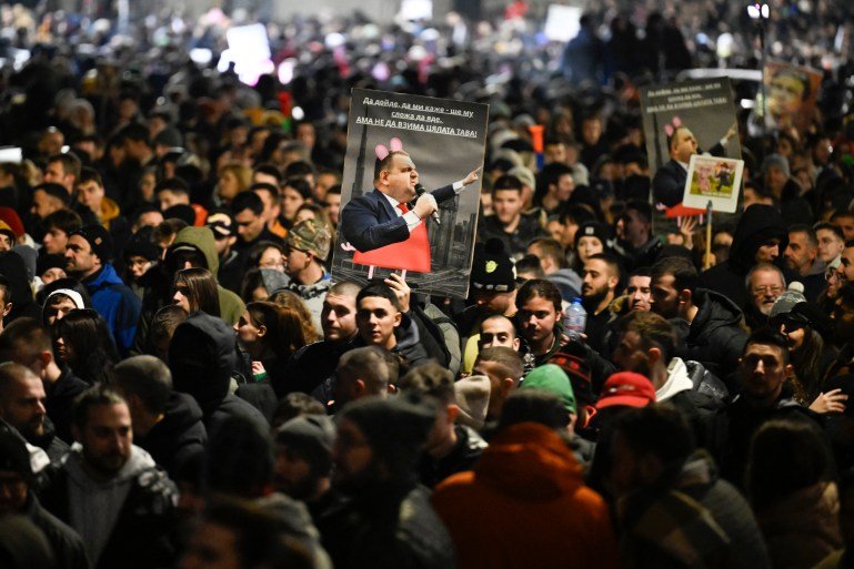 Protesters hold placards depicting Bulgarian politician Delyan Peevski during an anti-government protests in Sofia on December 1, 2025. Tens of thousands of people held anti-government protests in Bulgaria on Monday, widening an anti-corruption movement sweeping the European Union's poorest country as it prepares to adopt the euro. (Photo by Nikolay DOYCHINOV / AFP)