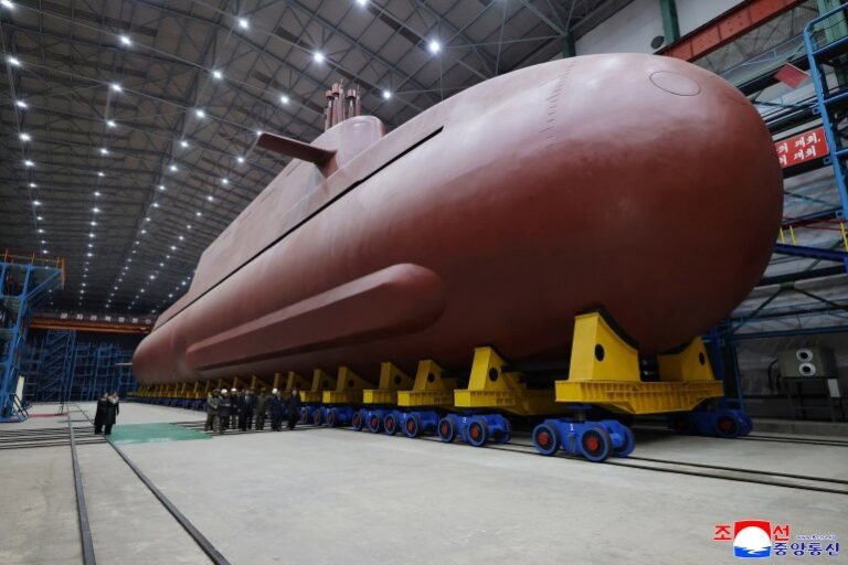 North Korean leader Kim Jong Un visits the construction site of an 8,700-ton nuclear-powered submarine capable of launching surface-to-air missiles in this picture released by North Korea's official Korean Central News Agency on December 25, 2025. KCNA via REUTERS ATTENTION EDITORS - THIS IMAGE WAS PROVIDED BY A THIRD PARTY. REUTERS IS UNABLE TO INDEPENDENTLY VERIFY THIS IMAGE. NO THIRD PARTY SALES. SOUTH KOREA OUT. NO COMMERCIAL OR EDITORIAL SALES IN SOUTH KOREA.
