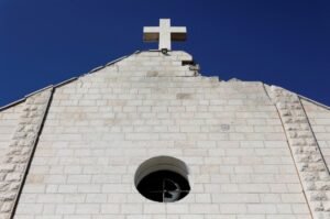 A view of the Holy Family Church which was damaged during the Israeli bombardment of the Gaza Strip, prior to the arrival of Palestinian Christians to celebrate Christmas Mass, in Gaza City, on December 24, 2025. The war was sparked by Hamas's October 7, 2023 attack on Israel, which resulted in the deaths of 1,221 people. Israel's retaliatory assault on Gaza has killed at least 69,733 people, according to figures from the health ministry that the UN considers reliable. (Photo by Omar AL-QATTAA / AFP)