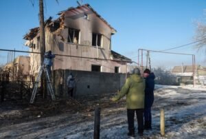 Residents stand at the site of the Russian drone strike, amid Russia's attack on Ukraine, near the city of Chornomorsk, Odesa region, Ukraine January 21, 2026. REUTERS/Nina Liashonok