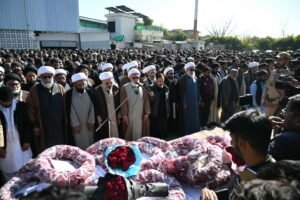 Mourners offer funeral prayers as they stand around the coffin of a Shiite Muslim, a day after a suicide bombing at a mosque in Islamabad on February 7, 2026.