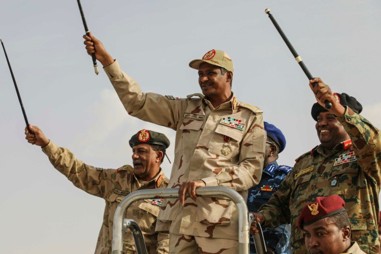 FILE - Gen. Mohammed Hamdan Dagalo, center, greets the crowd during a military-backed tribes' rally in the Nile River State of Sudan, on Saturday, July 13, 2019. (AP Photo/Mahmoud Hjaj,File)