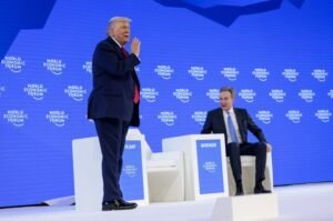 U.S. President Donald Trump gestures, as he stands next to the President and CEO of the World Economic Forum Borge Brende during the 56th annual World Economic Forum (WEF), in Davos, Switzerland, January 21, 2026. REUTERS/Jonathan Ernst