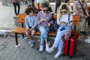RAFAH, GAZA - NOVEMBER 2: Citizens with foreign passports wait to travel through the Rafah crossing on November 2, 2023 in Rafah, Gaza. For the first time since the outbreak of war between Israel and Hamas on October 7, the crossing here at the Gaza-Egyptian border opened this week to allow a small number of foreign passport holders and seriously wounded to enter Egypt. The wounded have been taken to nearby hospitals, while Egypt is also preparing a field hospital in the area. (Photo by Ahmad Hasaballah/Getty Images)