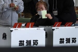 OSAKA, JAPAN - FEBRUARY 08: A voter casts her ballot at a polling station on February 08, 2026 in Osaka, Japan. Voters across the country headed to polls today as Japan's Lower House election was held. (Photo by Buddhika Weerasinghe/Getty Images)