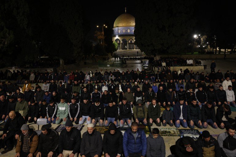 Palestinian Muslim worshippers perform Taraweeh prayers on the first night of the muslim holy month of Ramadan near the Dome of the Rock Shrine at the Al-Aqsa mosque compound, in the Old City of Jerusalem on February 17, 2026.