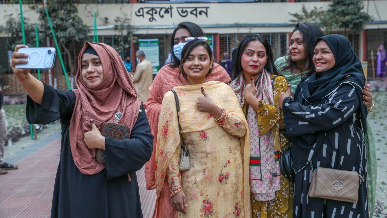 epa12731464 A group of young women take a selfie and show their inked thumbs after casting their votes at a polling centre at Dania College, at Dhaka Government Muslim High School in Dhaka, Bangladesh, 12 February 2026. Voters are selecting members of the national parliament and taking part in a referendum on proposed July National Charter constitutional reforms. EPA/MONIRUL ALAM