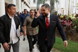 Nicolas Maduro Guerra walks with National Assembly members after discussions of an amnesty law