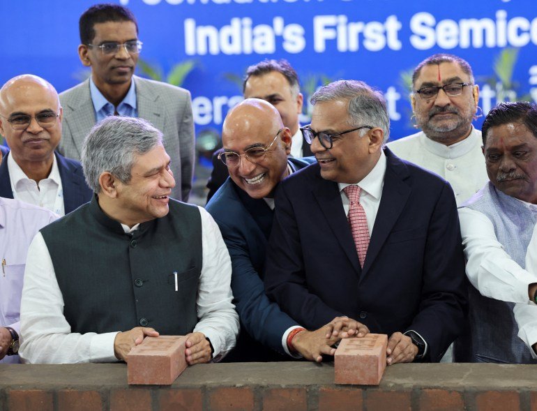 Ashwini Vaishnav, Union Minster of Railways, Communications and Electronics & Information Technology and N. Chandrasekaran, Chairman, Tata Sons hold bricks during the foundation stone laying ceremony for India's First AI-enabled Semiconductor Fab manufacturing facilities in Dholera, Gujarat, India, March 13, 2024. REUTERS/Amit Dave