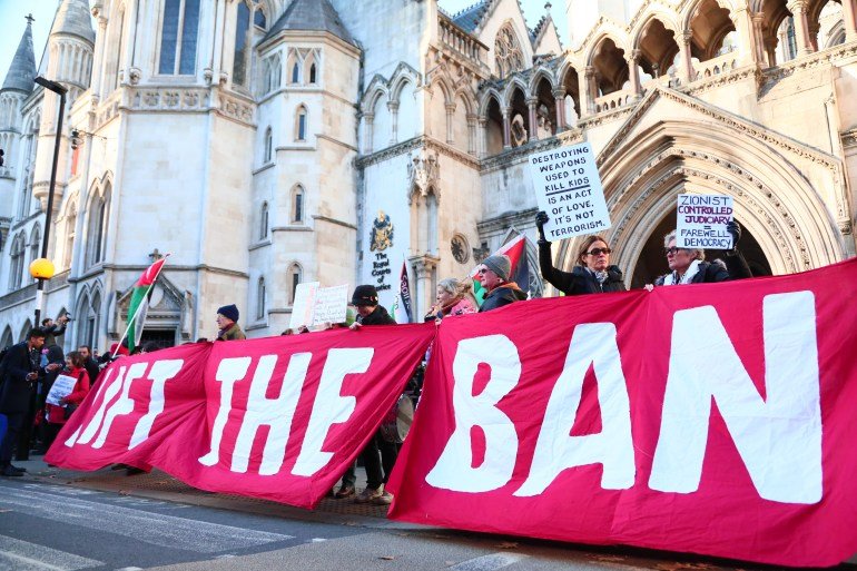Protesters gather outside The Royal Courts of Justice as the High Court hears a judicial review on the proscription of Palestine Action under the terrorism act on November 26, 2025 in London, United Kingdom. A three-day judicial review is being heard by the High Court on the proscription of Palestine Action (PA) as a terrorist group. PA co-founder Huda Ammori leads the challenge to the pro-Palestinian campaign group's proscription under the Terrorism Act 2000. Last month the Home Office lost an appeal to block the review, which was due to begin on November 25, but was postponed a day. The Home Office-imposed ban on membership or support of PA took effect on July 5, after activists from the pro-Palestinian group broke into RAF Brize Norton and spray-painted two Voyager aircraft. Since their proscription, more than 2,000 people have been arrested for allegedly showing support of PA, mostly while holding signs reading: "I oppose genocide, I support Palestine Action." (Photo by Alishia Abodunde/Getty Images)