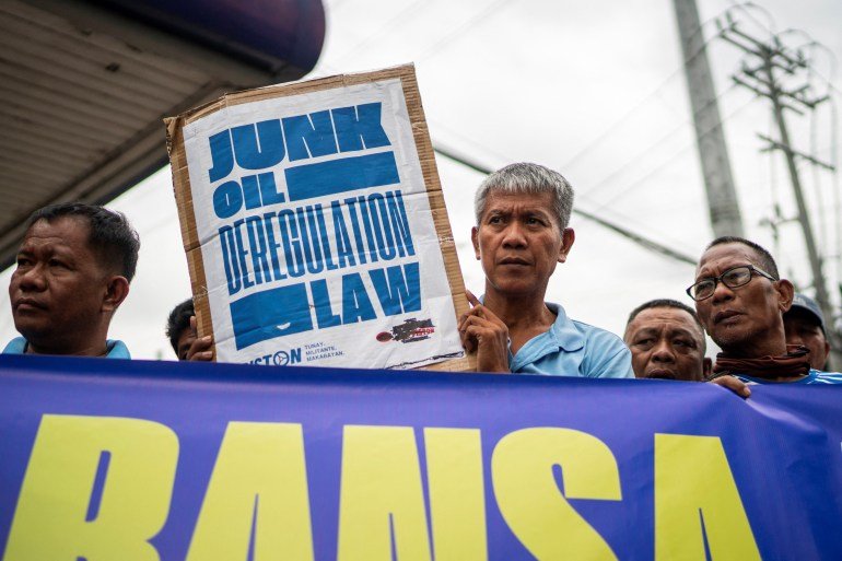 Members of a transport group, mostly jeepney drivers, hold a protest against oil price hike amid the U.S.-Israel conflict with Iran, near a gas station in Quezon City, Metro Manila, Philippines, March 9, 2026. REUTERS/Lisa Marie David