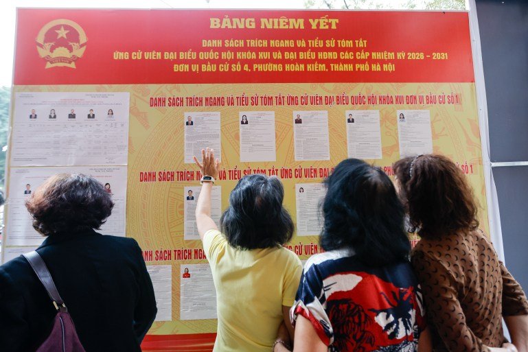 epa12820474 People look at the lists of candidates at a polling station in Hanoi, Vietnam 15 March 2026. Vietnam holds general elections for the 16th National Assembly and People's Councils at all levels for the 2026–2031 term on 15 March. EPA/LUONG THAI LINH